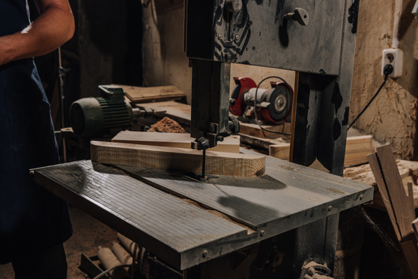 partial view of woodworker at wooden workshop - Fotografie, Obrázek