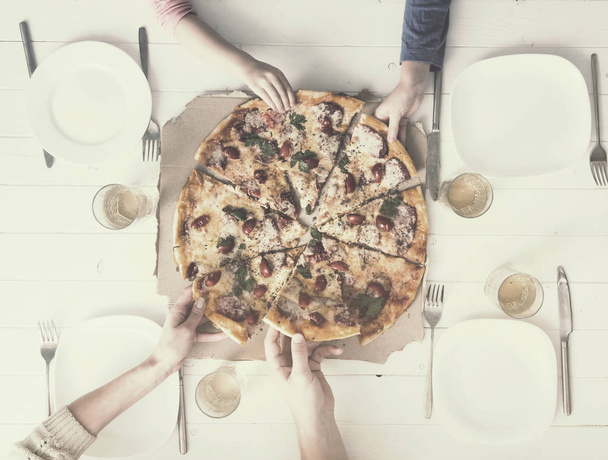 four hands taking pieces of pizza - Zdjęcie, obraz