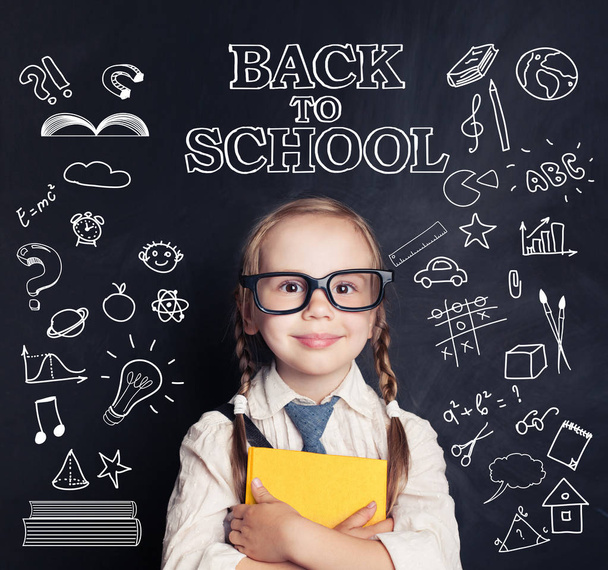 Cute child schoolgirl in classroom on blackboard background and pattern with school supplies and creative elements. Back to school concept - Photo, Image