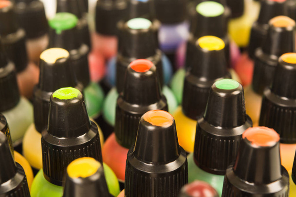Closeup view of colorful paints in bottles, soft focus - Фото, зображення