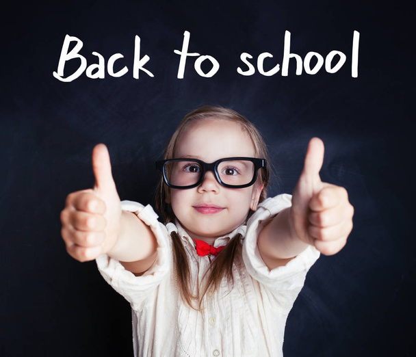 Happy kid in glasses with thumb up. Back to school. - Foto, imagen