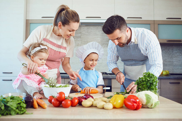 A happy family is preparing in the kitchen. - 写真・画像
