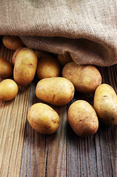 potato food . Fresh raw organic potatoes on old vintage background - Zdjęcie, obraz