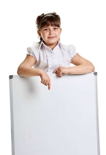 Schoolgirl pointing on whiteboard - Foto, imagen