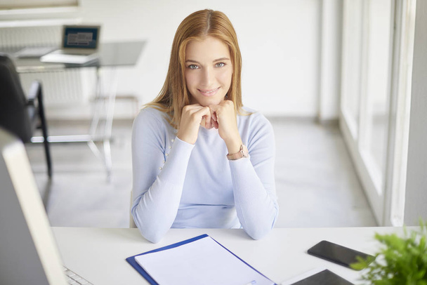 High angle shot of thinking young businesswoman sitting at office desk. - Foto, imagen