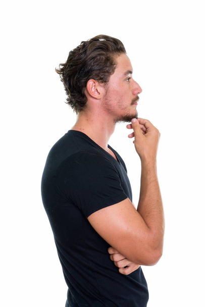 Profile view of young handsome man thinking isolated against whi - Photo, Image