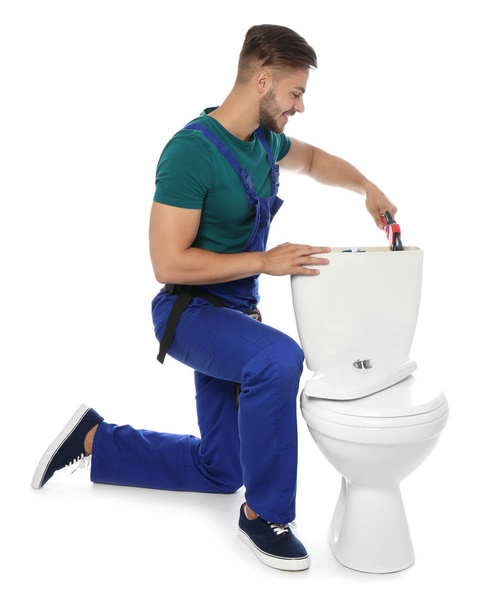 Young man working with toilet tank, isolated on white - Foto, Imagem