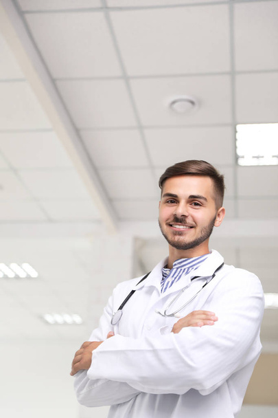Portrait of male doctor in coat at workplace - Foto, Imagem