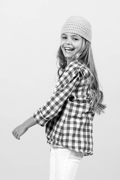 Happy childhood, youth. Small girl smile in hat, shirt and pants, fashion. Child smiling with long blond hair, beauty. Kid fashion, beauty, style. Punchy pastel trend. - Photo, Image