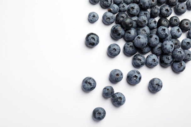 Flat lay composition with tasty blueberry and space for text on white background - Φωτογραφία, εικόνα