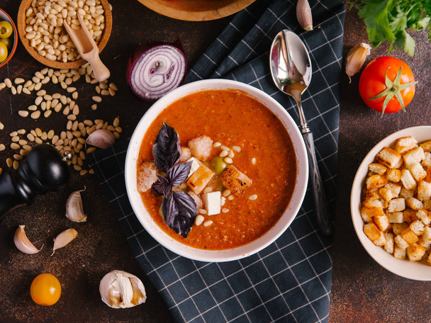 Верхний вид овощного супа подается с гренками, кедровыми орехами, сыром и листьями базилика
 - Фото, изображение