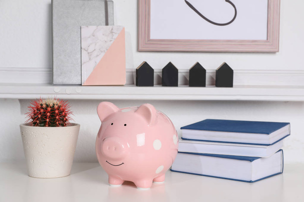 Color piggy bank on table in room. Cute interior element - Foto, Imagen