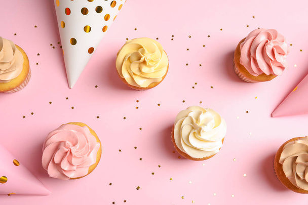 Flat lay composition with delicious birthday cupcakes on color background - Fotó, kép