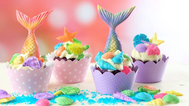 Mermaid theme cupcakes with colorful glitter tails, shells and sea creatures toppers for childrens, teens, novelty birthday and party celebrations. - Photo, Image