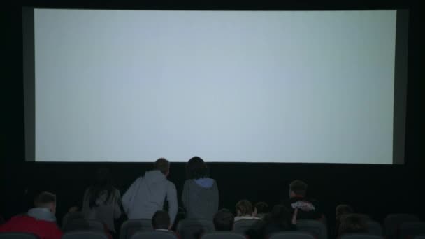 Θεατές χειροκροτούν κινηματογράφου που έληξε. Κοινό αφήνοντας χειροκροτούν κινηματογράφος - Πλάνα, βίντεο