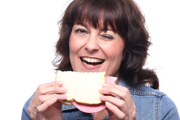 Adult woman with sandwich close up - Foto, afbeelding