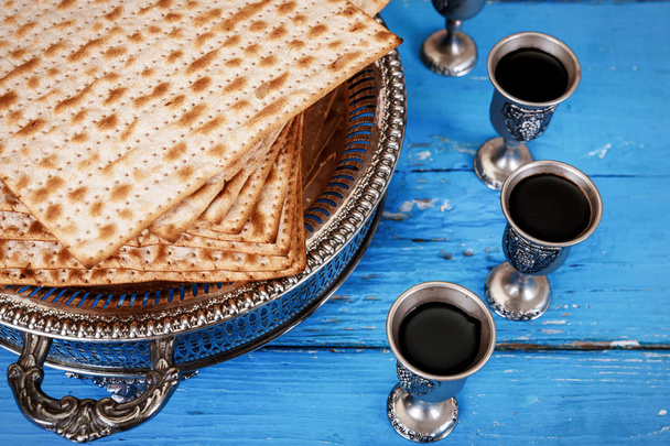 Matzot and red wine four glasses of symbols of Passover - Photo, Image