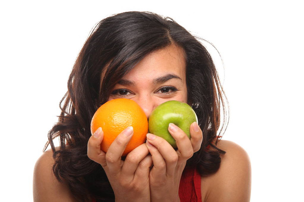 Beautiful afro-american woman is holding apple and orange - Φωτογραφία, εικόνα