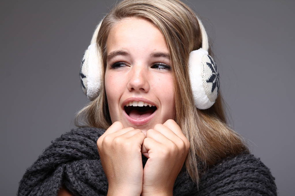 Blonde girl in winter clothes and headphones - Photo, Image