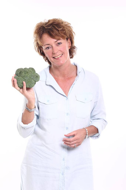 Woman holding broccoli in hands - Fotografie, Obrázek