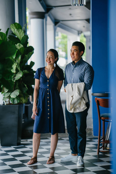 Portrait of an Asian Chinese couple on a date over the weekend. The man is young, handsome and well-dressed and the woman is wearing an elegant summer dress.  - Foto, Imagem
