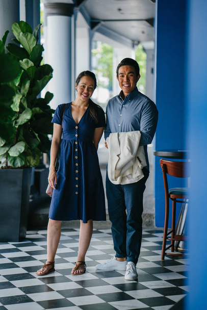 Portrait of an Asian Chinese couple on a date over the weekend. The man is young, handsome and well-dressed and the woman is wearing an elegant summer dress.  - Fotó, kép