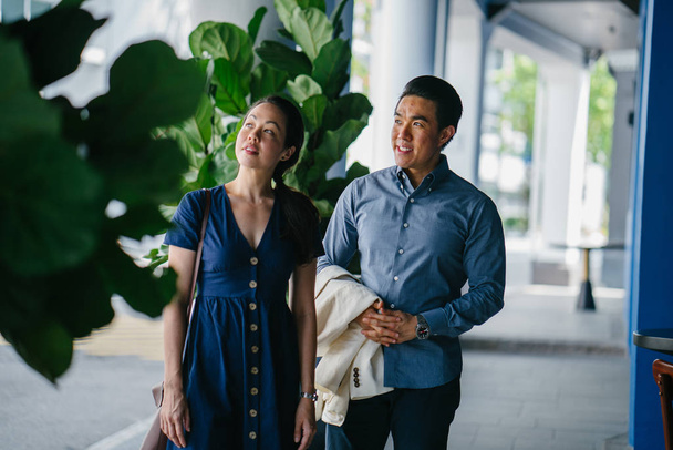 Portrait of an Asian Chinese couple on a date over the weekend. The man is young, handsome and well-dressed and the woman is wearing an elegant summer dress.  - Фото, зображення