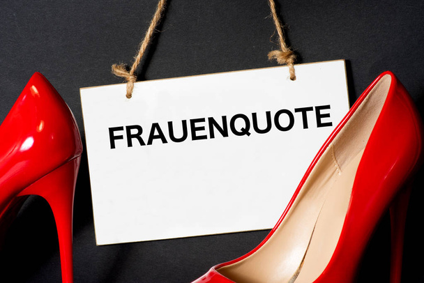 Two high heels and a sign with the imprint Frauenquote - Photo, Image