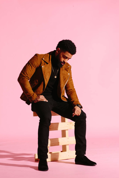 Stylish, handsome and cool African American man with beard, isolated on pink studio background - Φωτογραφία, εικόνα