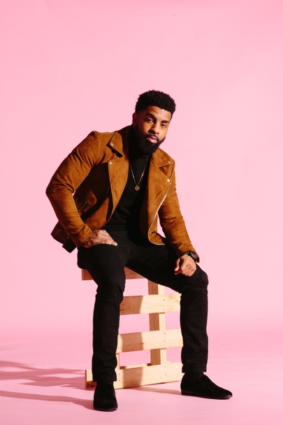 Stylish, handsome and cool African American man with beard, isolated on pink studio background - Fotoğraf, Görsel