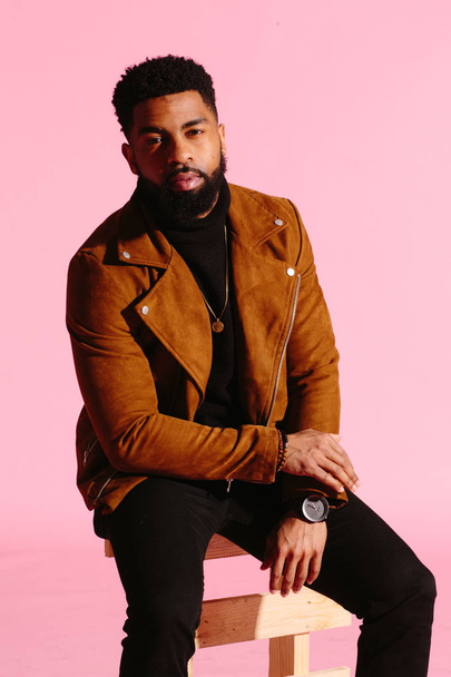 Stylish, handsome and cool African American man with beard, isolated on pink studio background - Valokuva, kuva