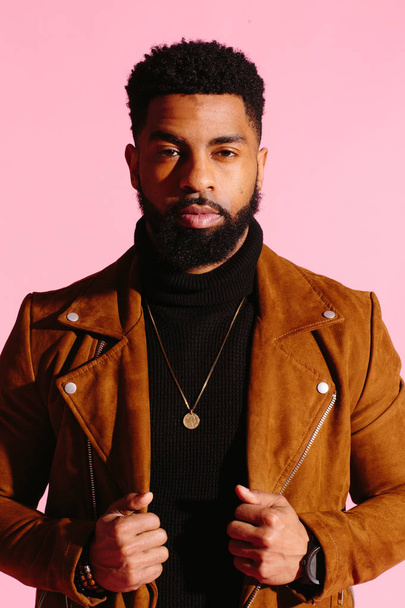 Stylish, handsome and cool African American man with beard, isolated on pink studio background - Foto, afbeelding