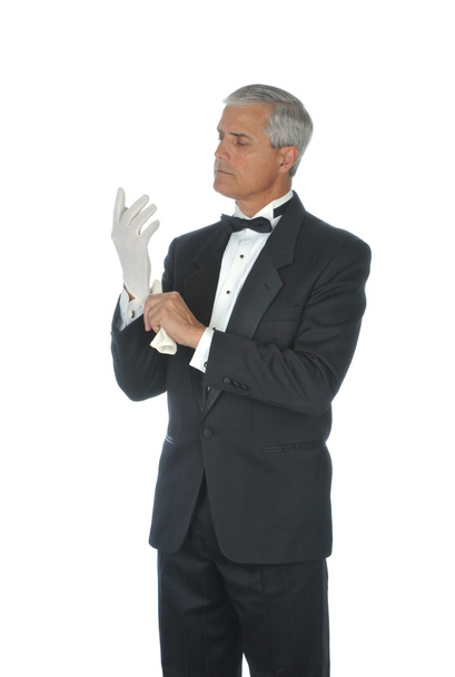 Man in Tux Putting on White Gloves - 写真・画像