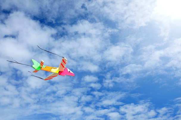 Kolorowe zabawki płaszczyzny przechodzącej przez błękitne niebo - Zdjęcie, obraz