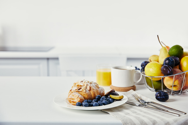 vista de cerca del delicioso desayuno con croissant y taza de café en la superficie blanca
 - Foto, Imagen