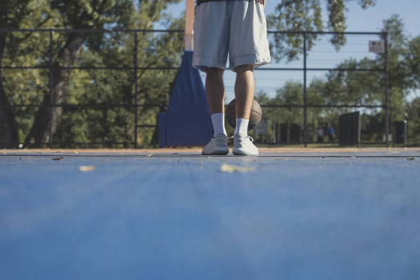 Legs of unrecognisable basketball player standing on court. - Fotografie, Obrázek