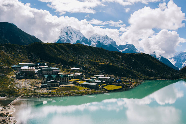 Mountain range with beautiful clouds. Mountain landscape. View on the lake Gokyo Ri. Blue sky with clouds. Himalaya mountains of Nepal, snow covered high peaks and lake not far from Everest. - Foto, Imagem