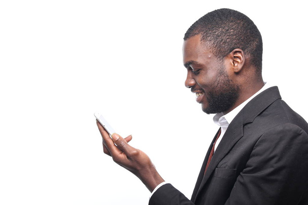 Black businessman holding a mobile phone - Foto, Imagem