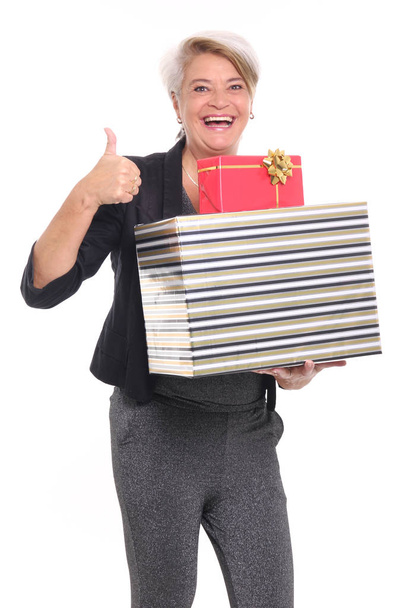 Woman holding holiday gift boxes on white background - 写真・画像