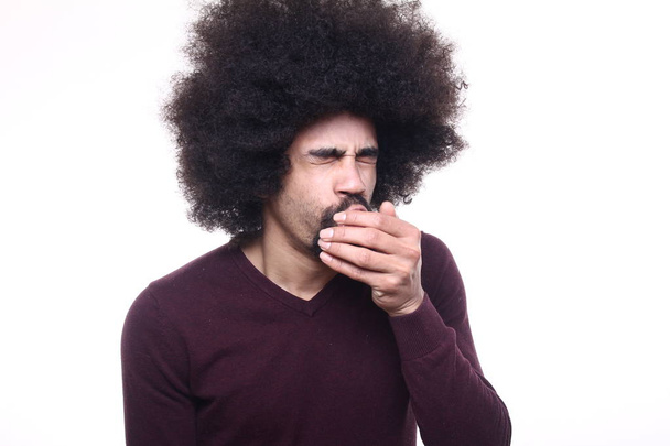 Afro-american man yawns on white background - Fotoğraf, Görsel