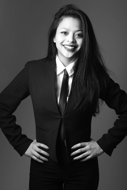 Smiling asian young woman on black and white tone - Foto, Bild