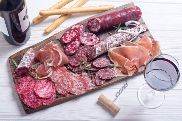 Assortment of sausages . Ham , salami and jamon on wooden board  - Foto, Imagem