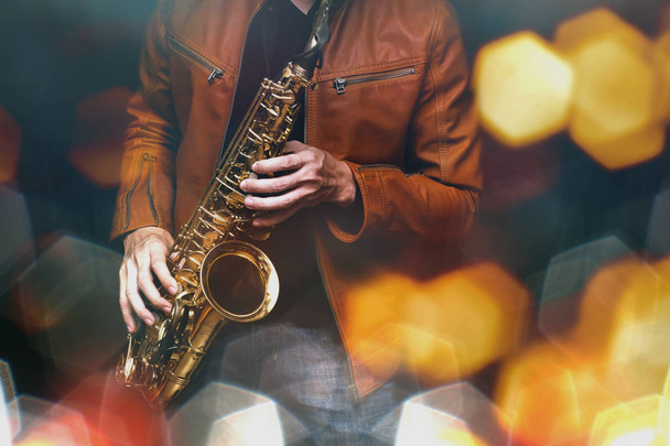 Jazz saxophone player in performance on the stage. color filter and hexagon bokeh added. - Zdjęcie, obraz