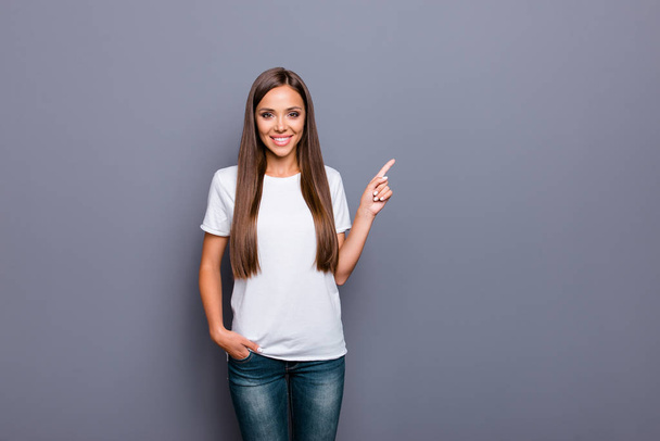 Attractive woman in a white tshirt pointing with her index finge - Zdjęcie, obraz
