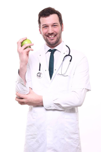 男性医師の聴診器とリンゴと特別な制服を着て - 写真・画像