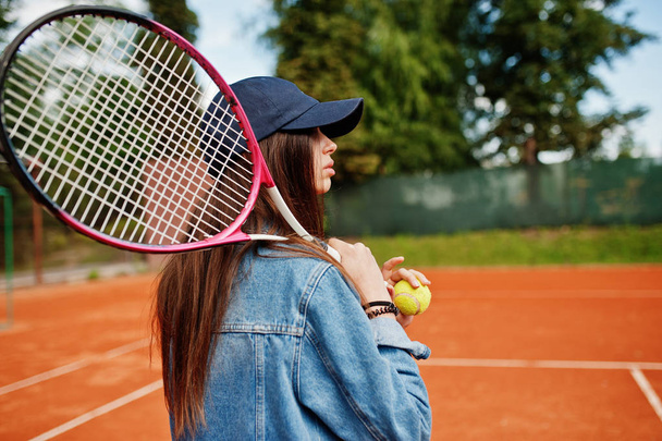 Young sporty girl player with tennis racket on tennis court. - Foto, afbeelding