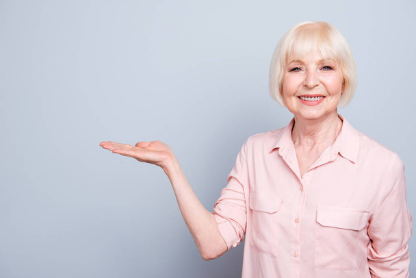 Old adult blonde glad cheerful lady smiling, showing gesture wit - Foto, afbeelding