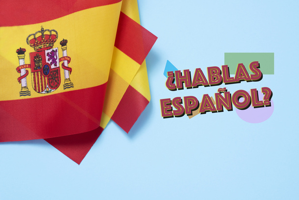 quelques drapeaux de l'Espagne et la question hablas espanol ? Parlez-vous espagnol ? écrit en espagnol, sur fond bleu
 - Photo, image