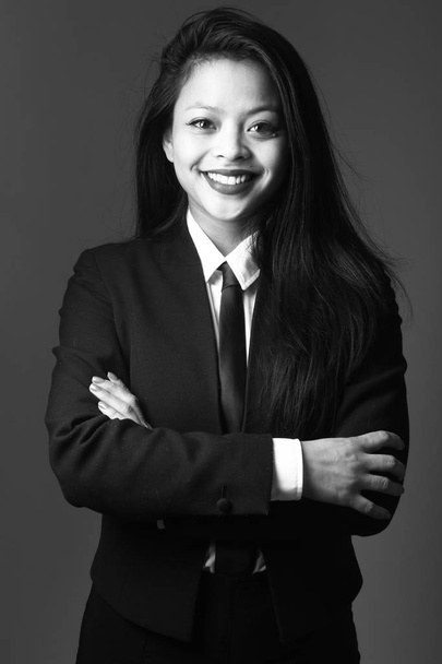 Smiling asian young woman on black and white tone - Foto, afbeelding
