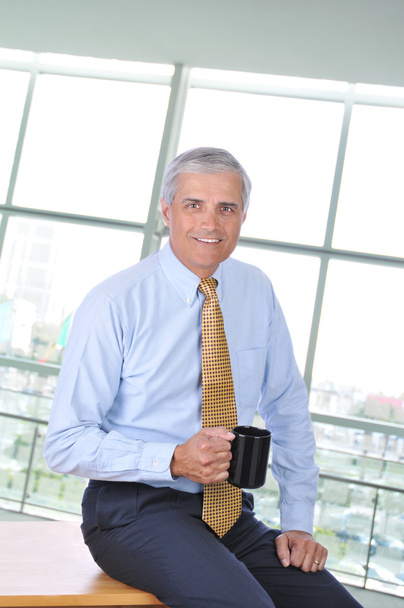 Businessman Sitting on Desk With Coffee - Photo, image